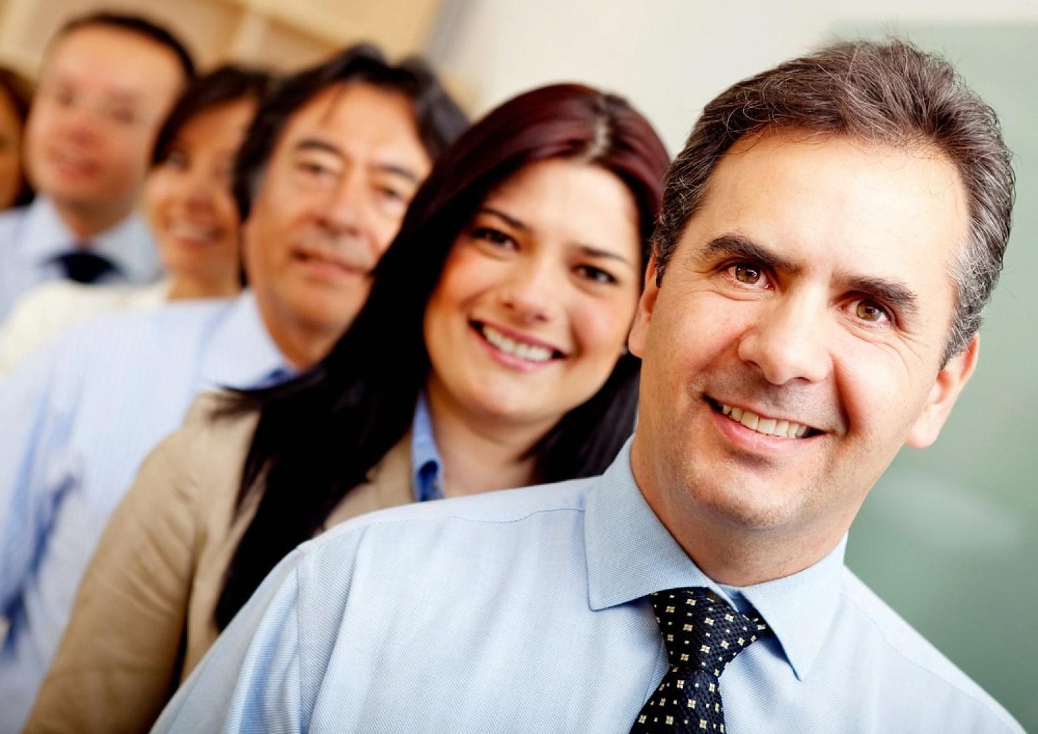 Group of office employees smiling, illustrating workplace rights and protection in the UAE